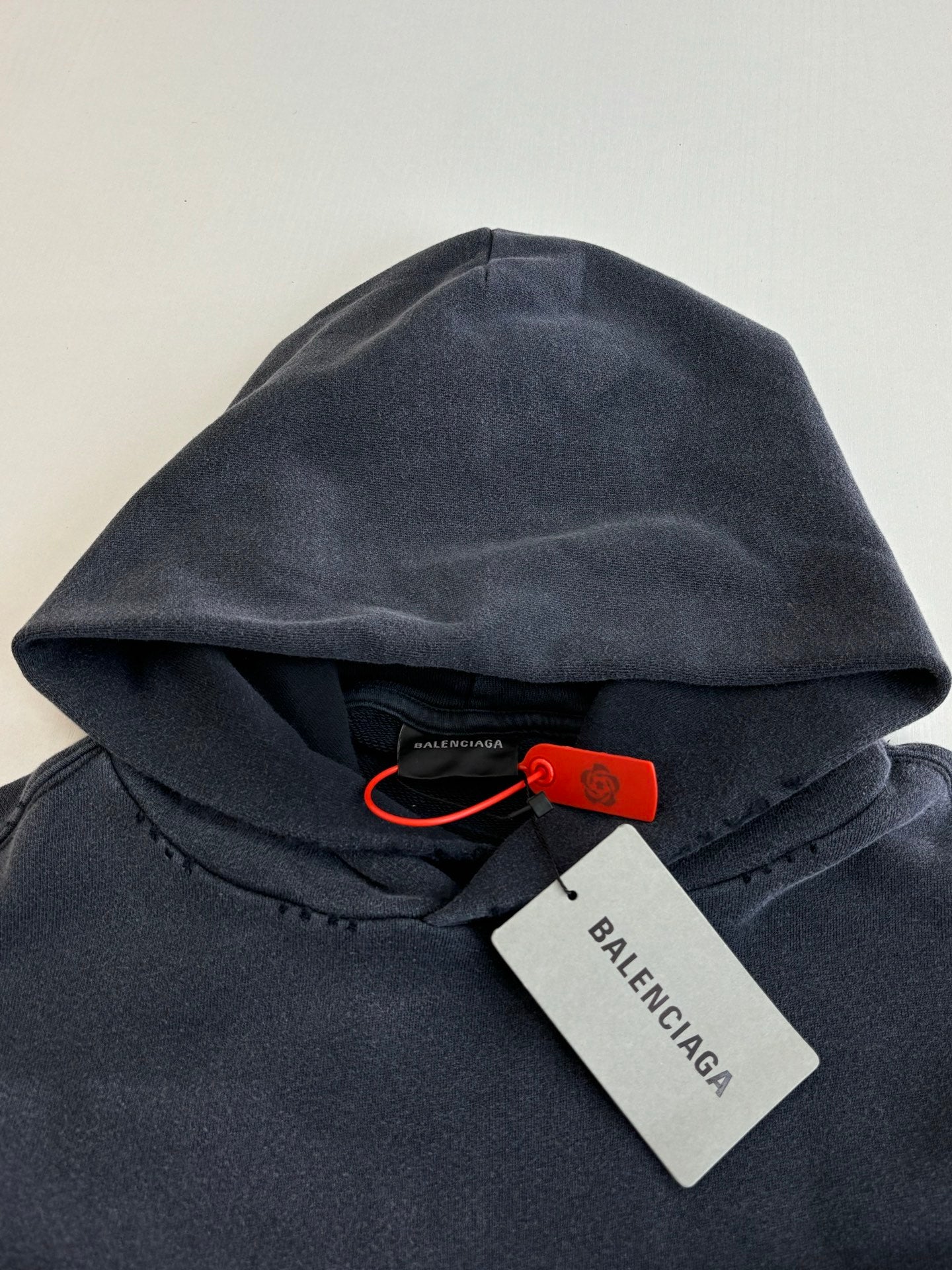 Navy Balenciaga hoodie hood with drawstring and red brand tag