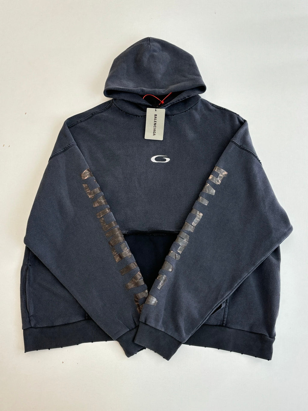 Navy Balenciaga hoodie with hood, front logo, and V-shaped sleeve embroidery