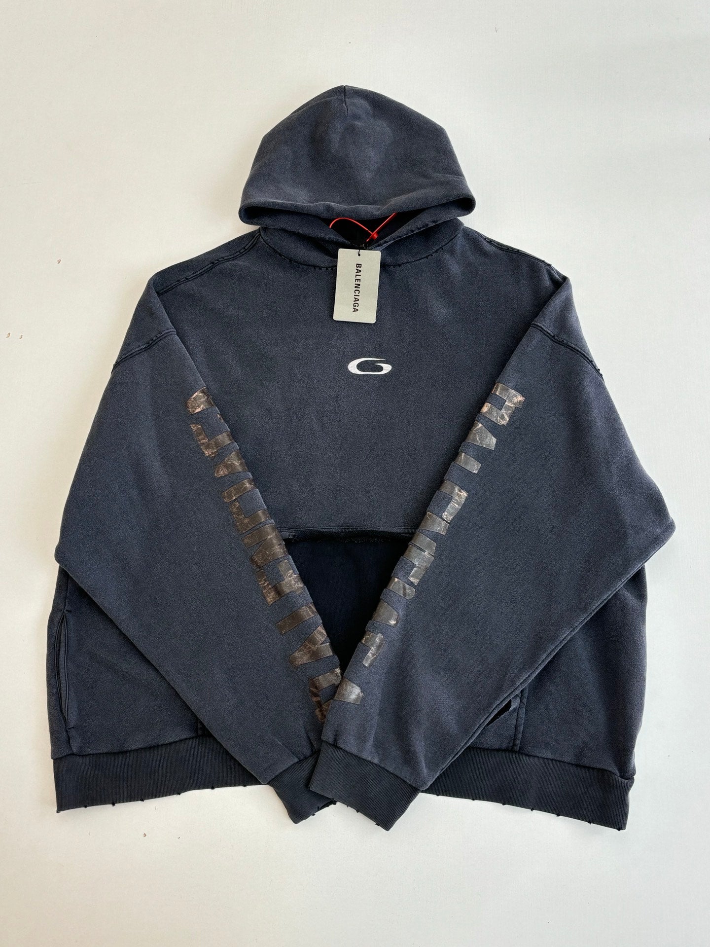 Navy Balenciaga hoodie with hood, front logo, and V-shaped sleeve embroidery