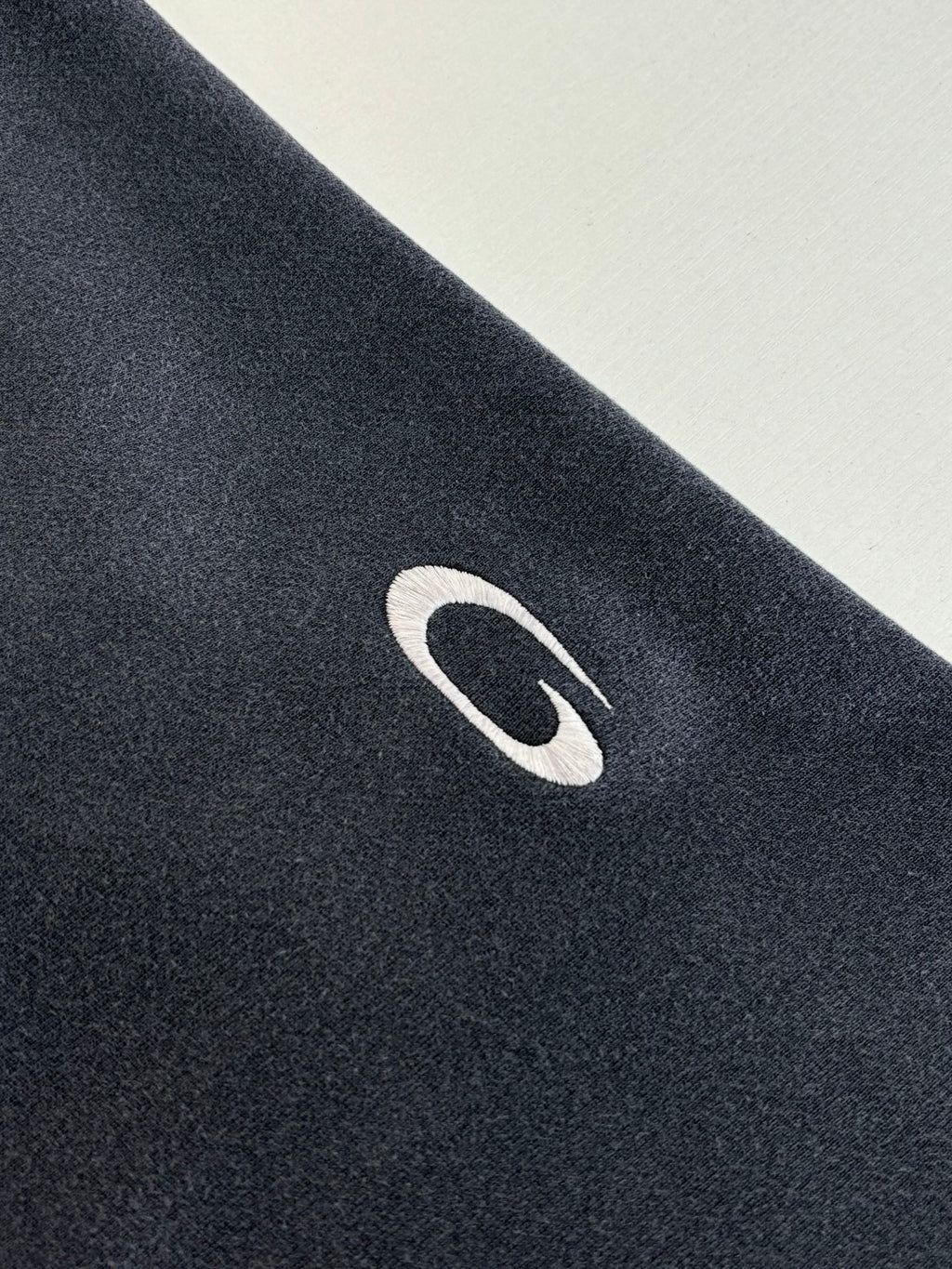 Navy Balenciaga hoodie fabric with white oval logo detail