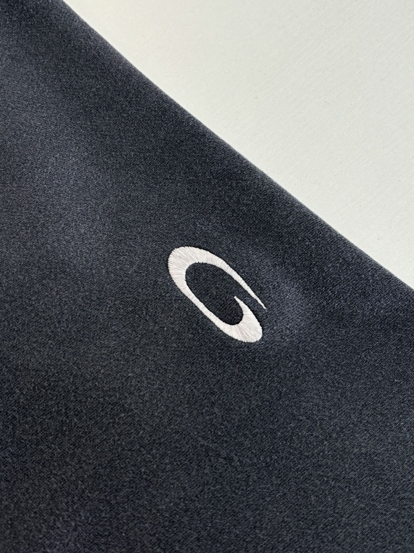 Navy Balenciaga hoodie fabric with white oval logo detail