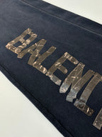 Balenciaga dark navy sweatpants leg with metallic logo lettering across front