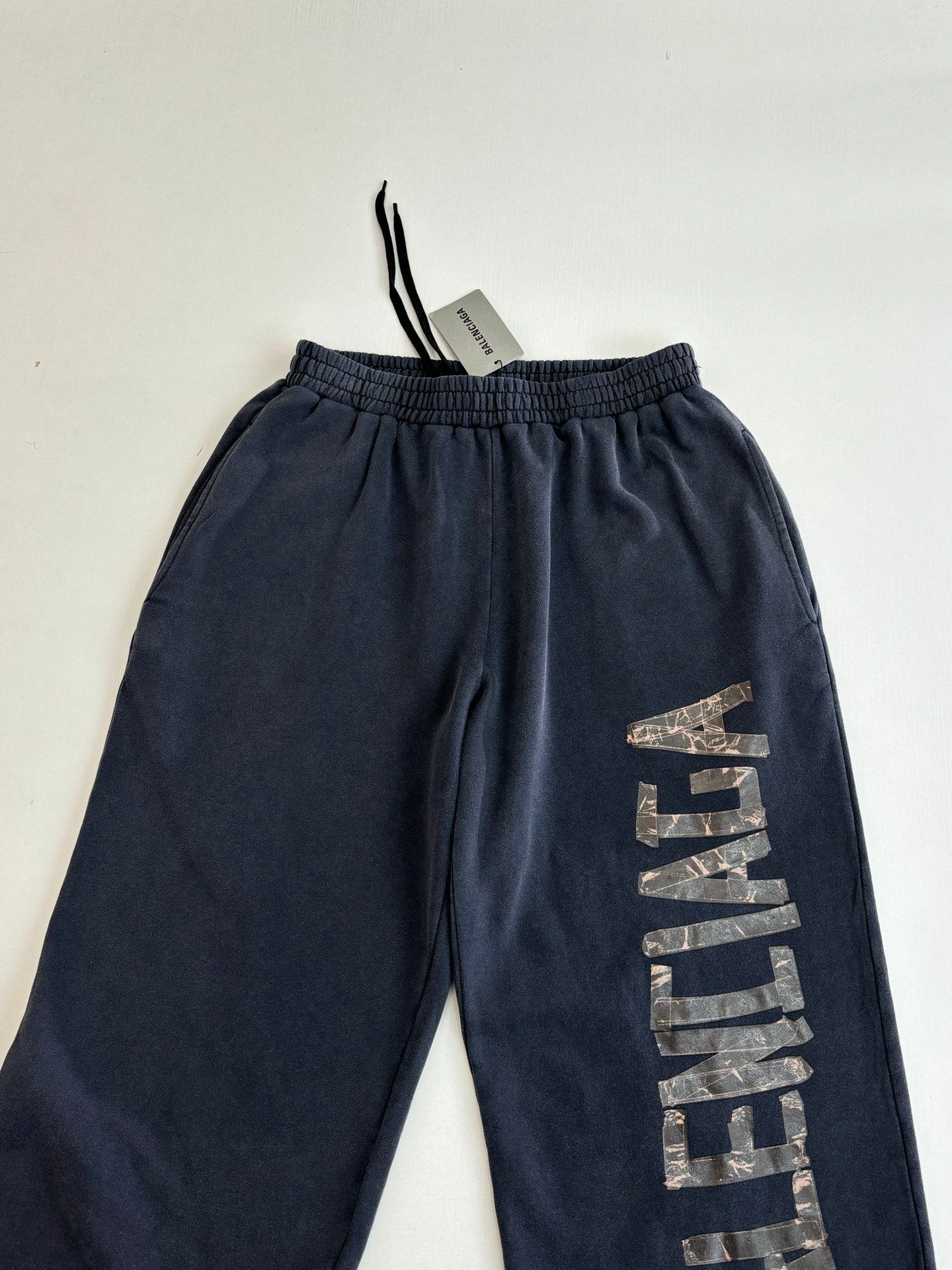 Balenciaga dark navy sweatpants with elastic waistband and vertical logo print