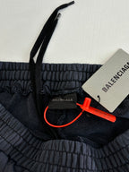 Balenciaga dark navy sweatpants with elastic waistband, red tag, and drawstring cord