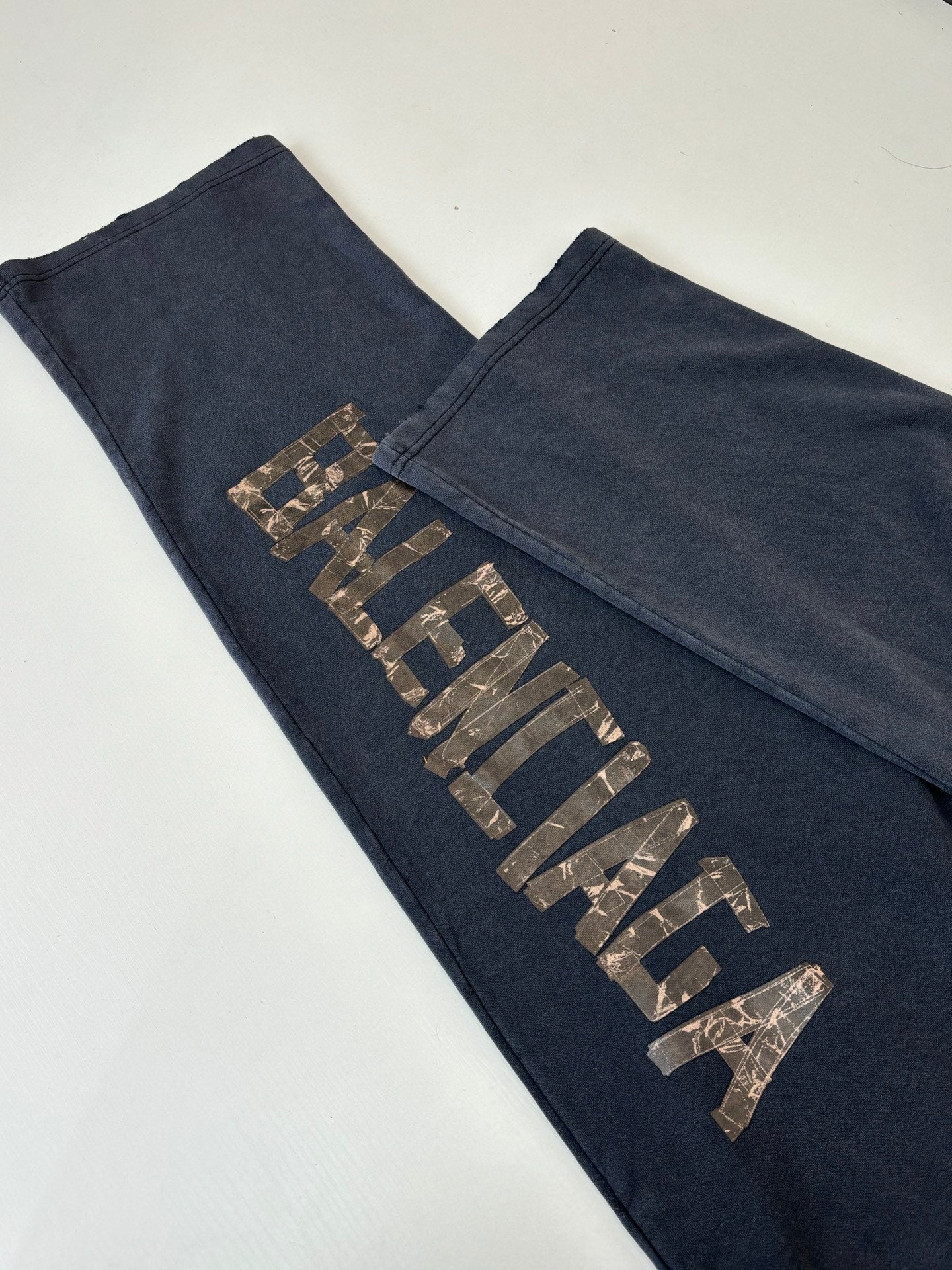 Balenciaga dark navy sweatpants leg with metallic vertical logo lettering