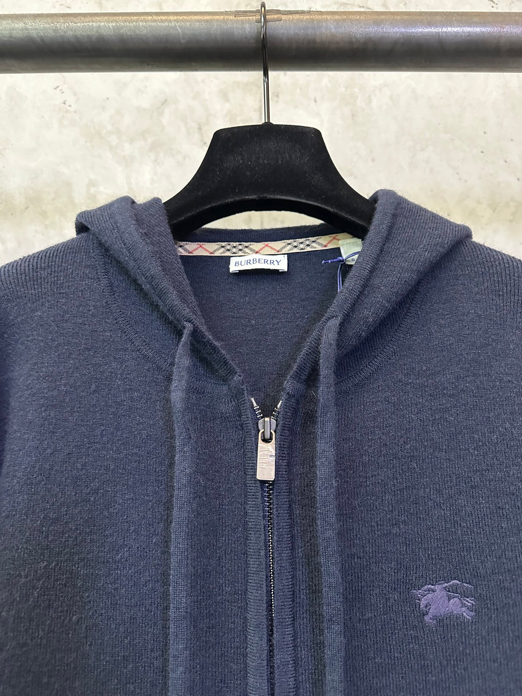 Men's Burberry navy hoodie close-up: front zipper, hood drawcords, small chest logo