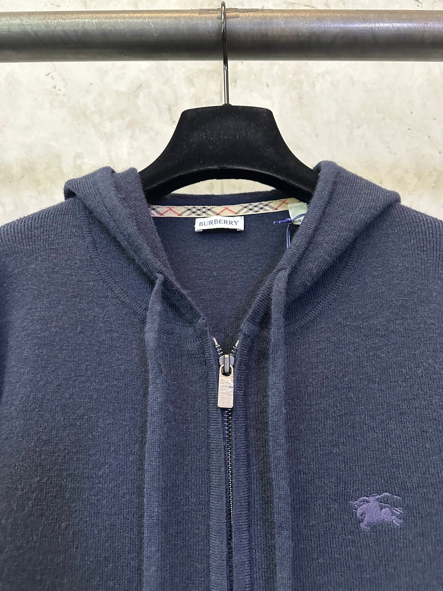 Men's Burberry navy hoodie close-up: front zipper, hood drawcords, small chest logo