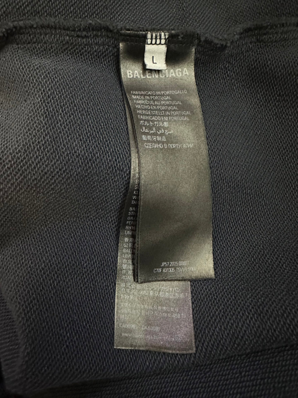 Balenciaga size label inside dark blue pants with care and fabric information