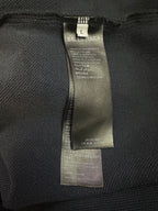 Balenciaga size label inside dark blue pants with care and fabric information
