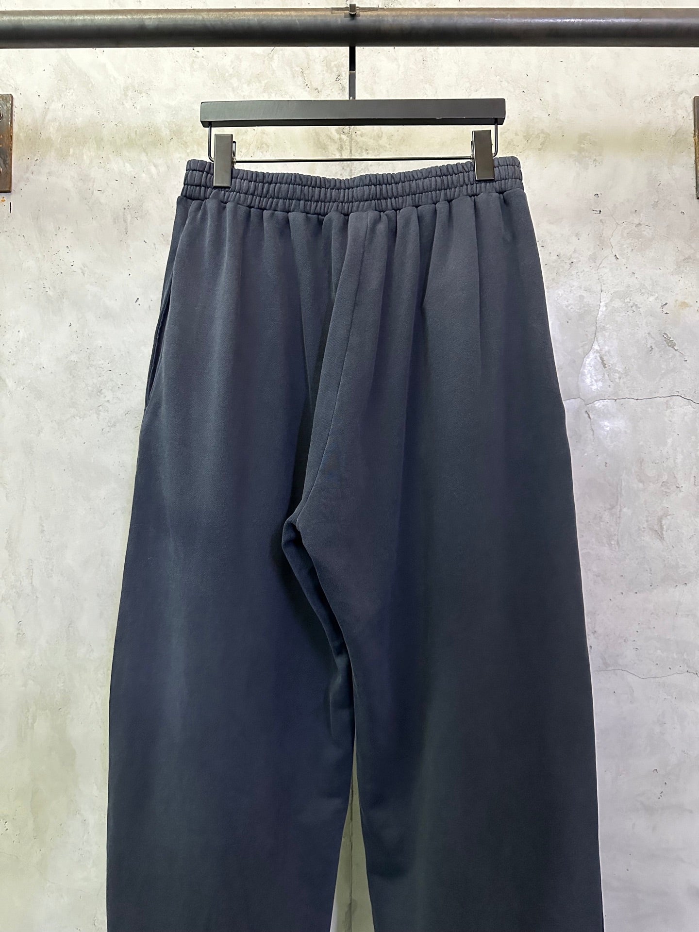 Dark blue wide-leg pants with elastic waistband and relaxed straight legs