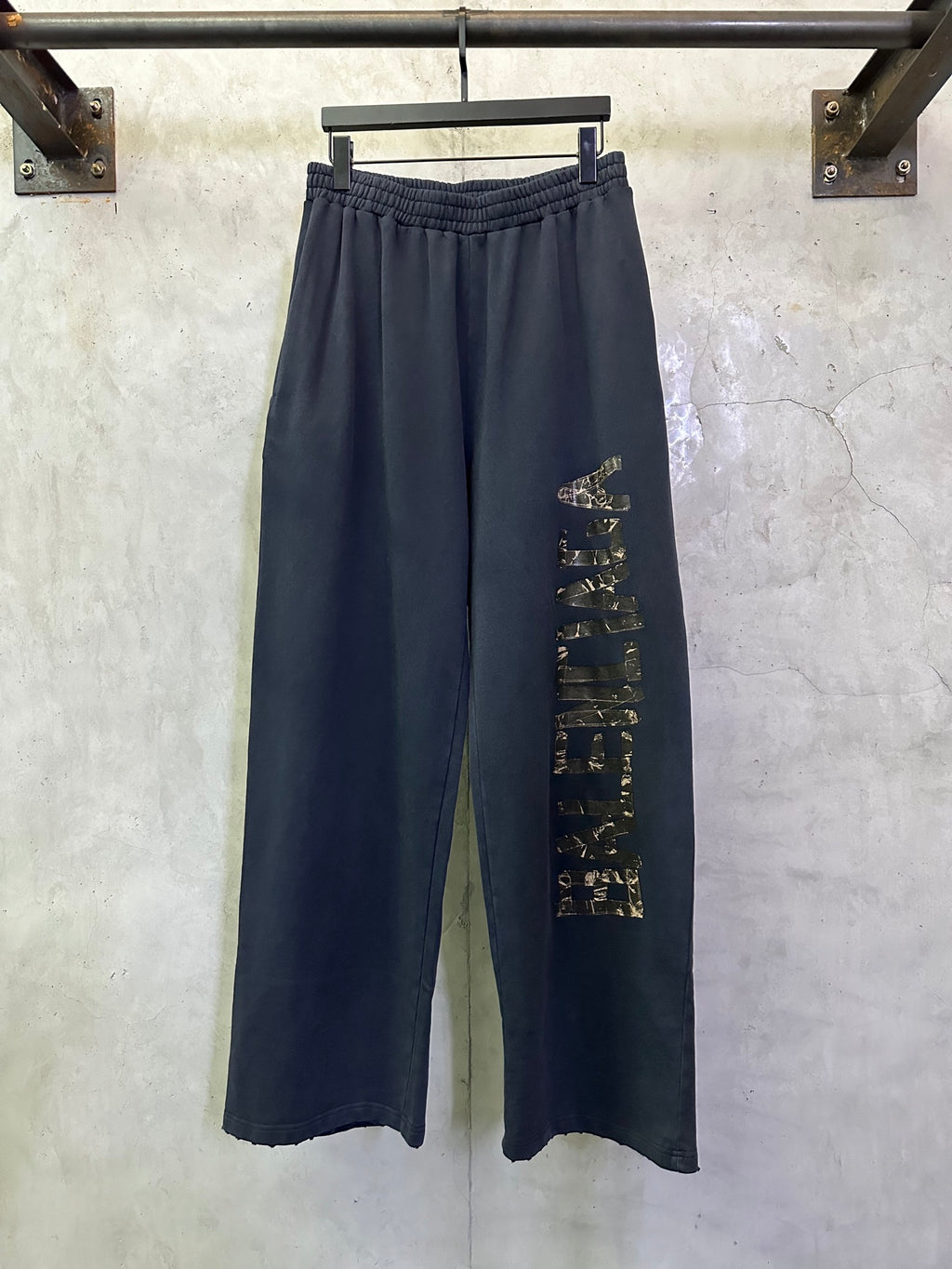 Dark blue wide-leg pants with elastic waistband and side graphic print