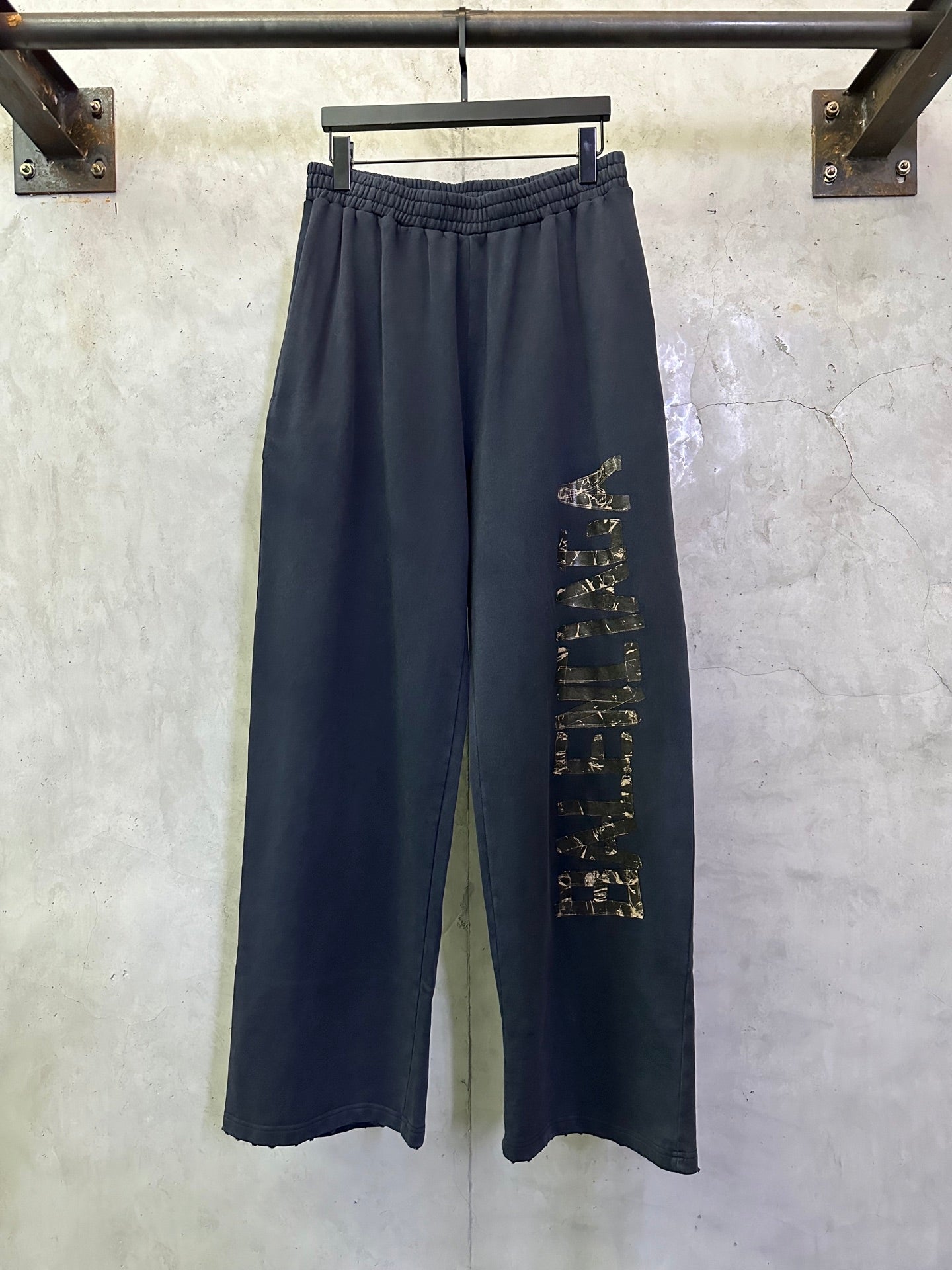 Dark blue wide-leg pants with elastic waistband and side graphic print