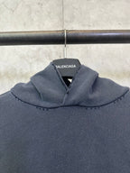 Balenciaga long-sleeve hoodie, dark gray, close-up of hood with brand label
