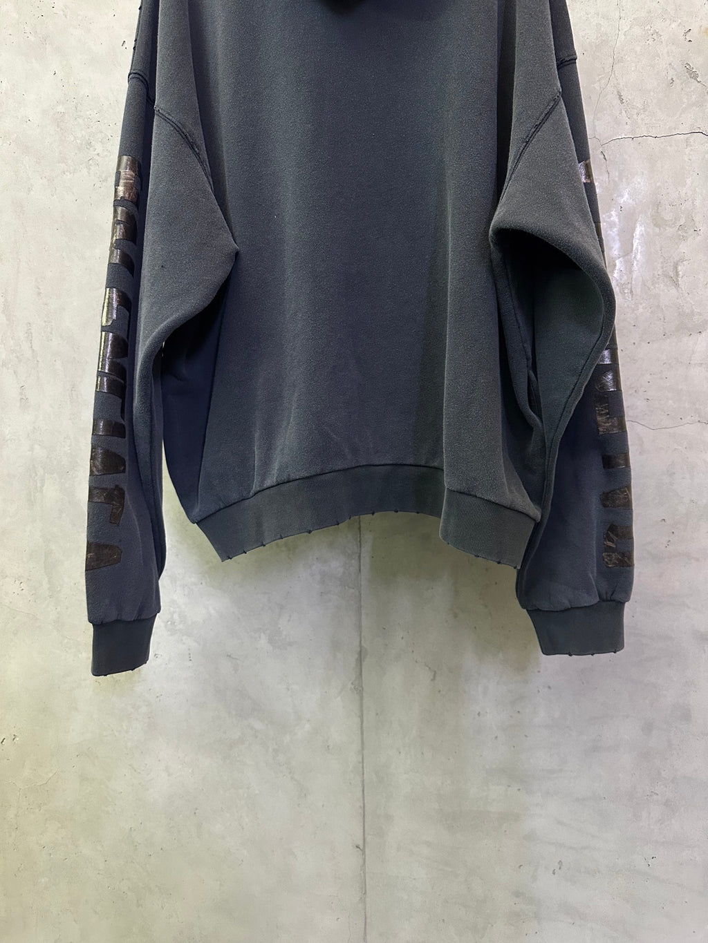 Balenciaga long-sleeve hoodie, dark gray, cropped back view with ribbed cuffs and hem