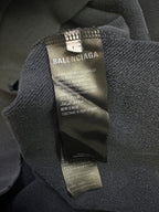 Balenciaga hoodie neck label and care tag inside collar on dark gray fabric