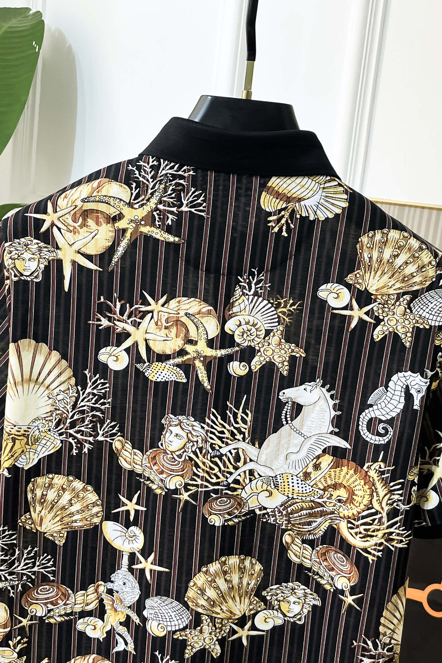 Black button-up shirt with gold and white shell, starfish, and animal graphic print