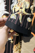 Black shirt sleeve hem with contrast trim and gold graphic pattern