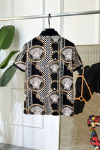 Versace short-sleeve shirt with checkerboard print, gold chain details, and Medusa-style emblems