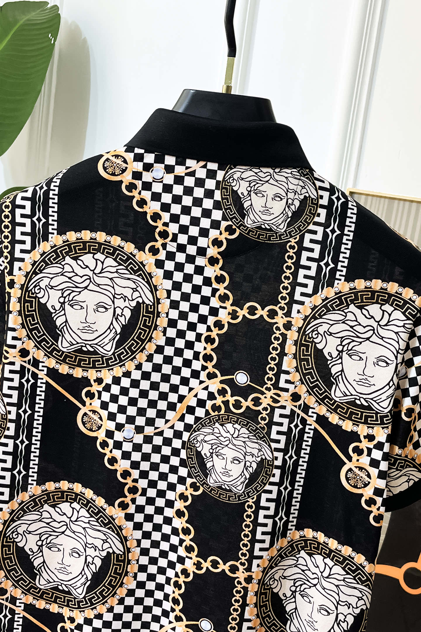 Versace printed shirt front with Medusa medallions, checkerboard blocks, and gold chain links