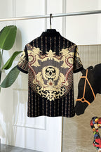 Black Versace polo shirt with gold baroque medallion and chain details