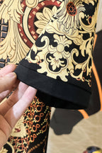 Versace polo shirt hem detail with gold baroque floral print