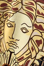 Versace polo shirt fabric close-up of lion illustration in gold and red
