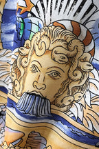 Versace polo shirt fabric detail with close-up bearded face in gold and blue tones