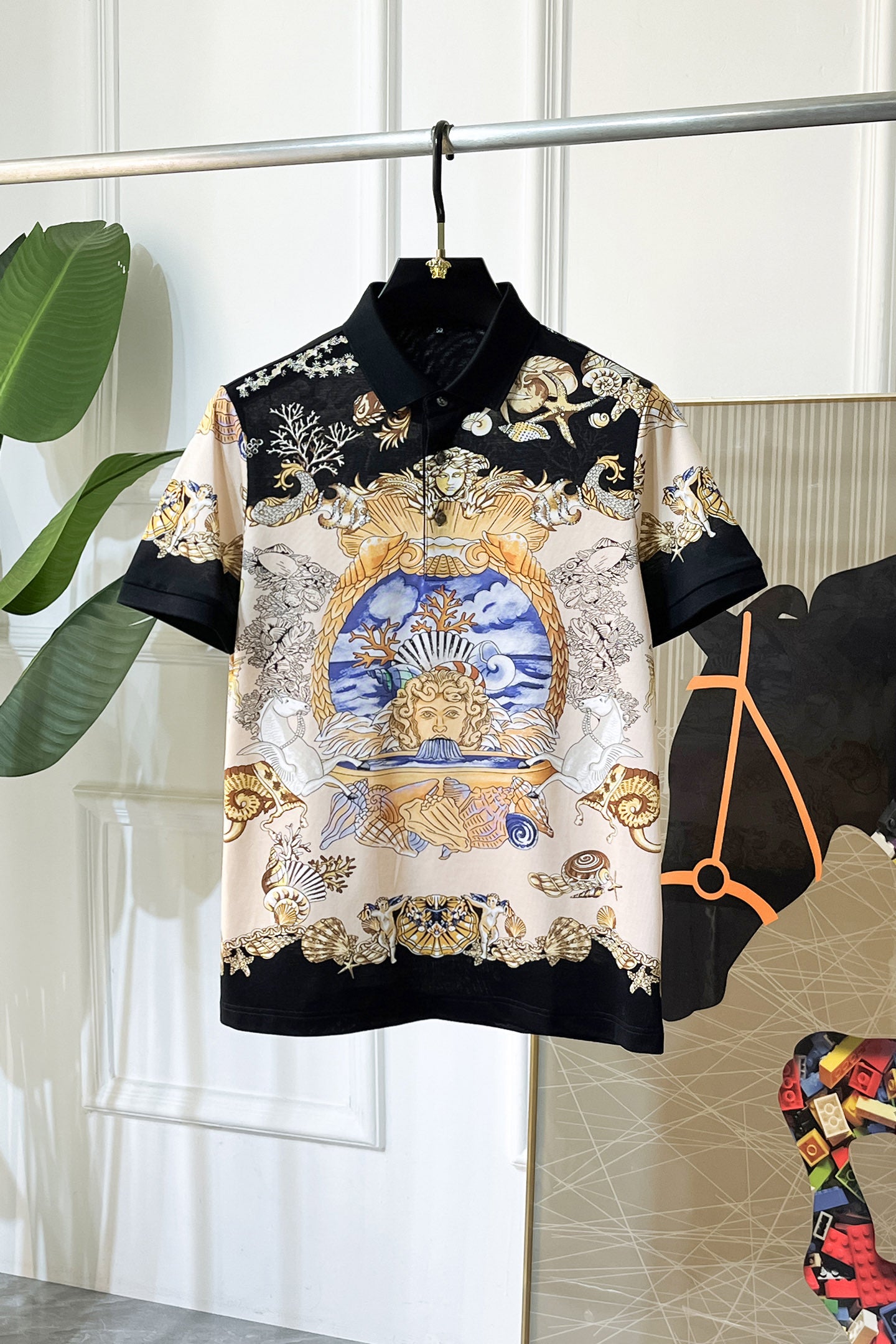 Versace short-sleeve polo shirt with black collar and ornate gold, blue, white print