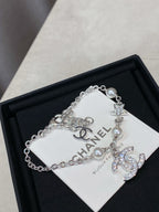 Silver charm bracelet with pearl beads and star, flower, and CC logo charms