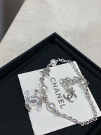 Silver charm bracelet with pearl beads and interlocking CC logo charm on card