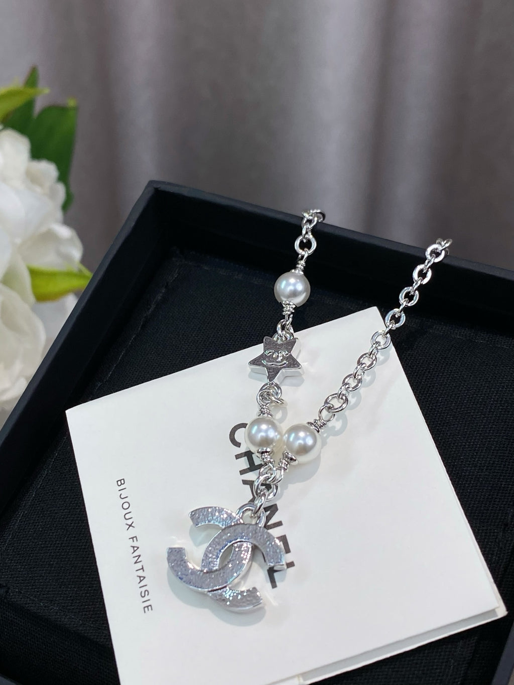 Silver charm bracelet with pearl beads and CHANEL-style letter charms on card