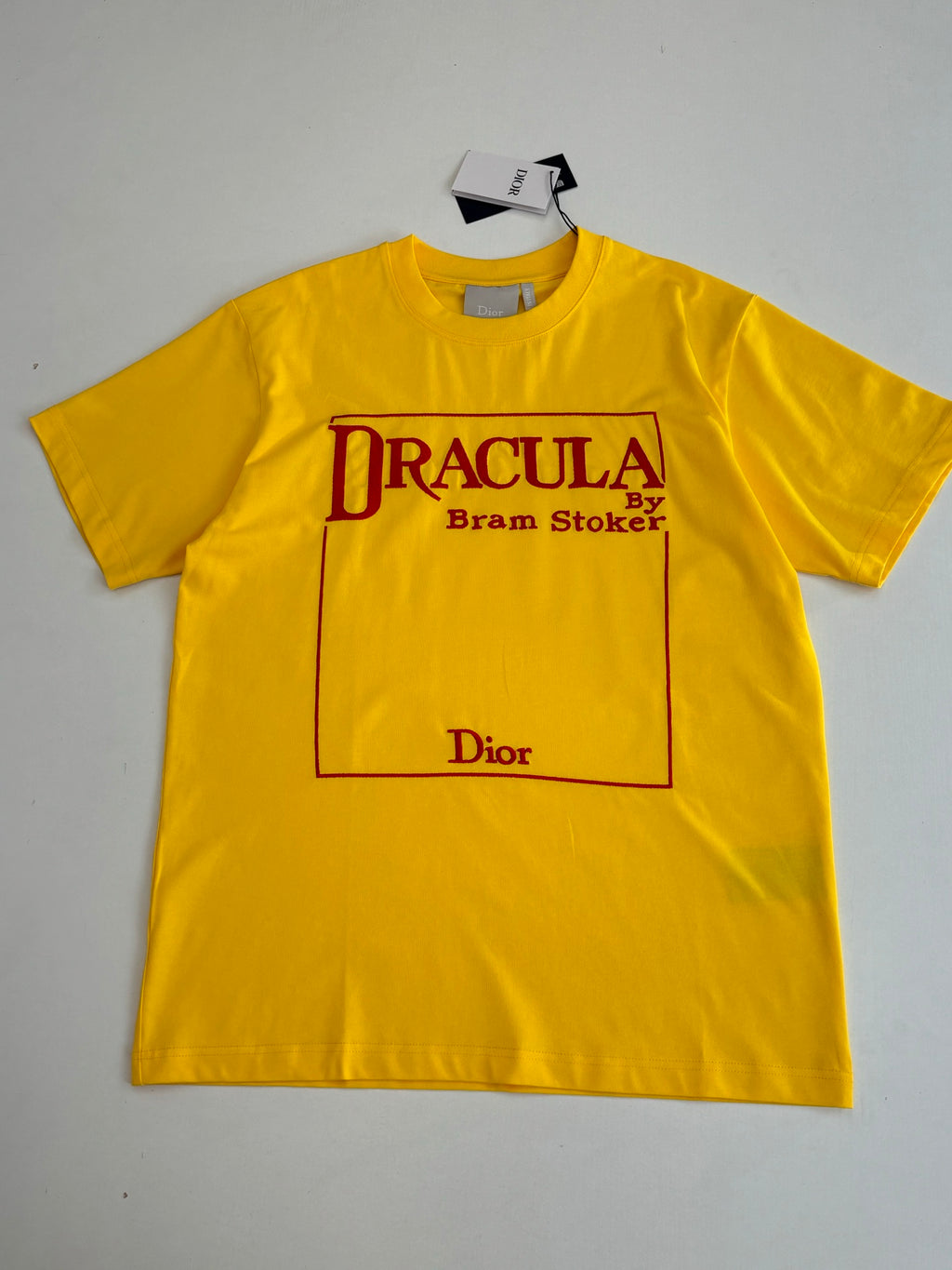 Yellow short-sleeve T-shirt with “DRACULA” front graphic and logo box.