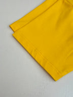 Yellow short-sleeve T-shirt sleeve and hem edge with visible stitching.