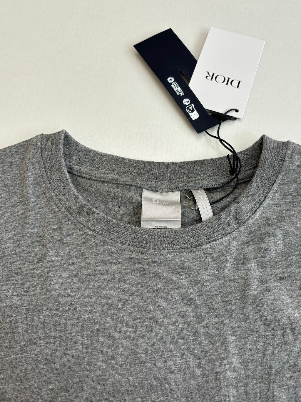 Gray crew-neck T-shirt with neck label and inside seam detail
