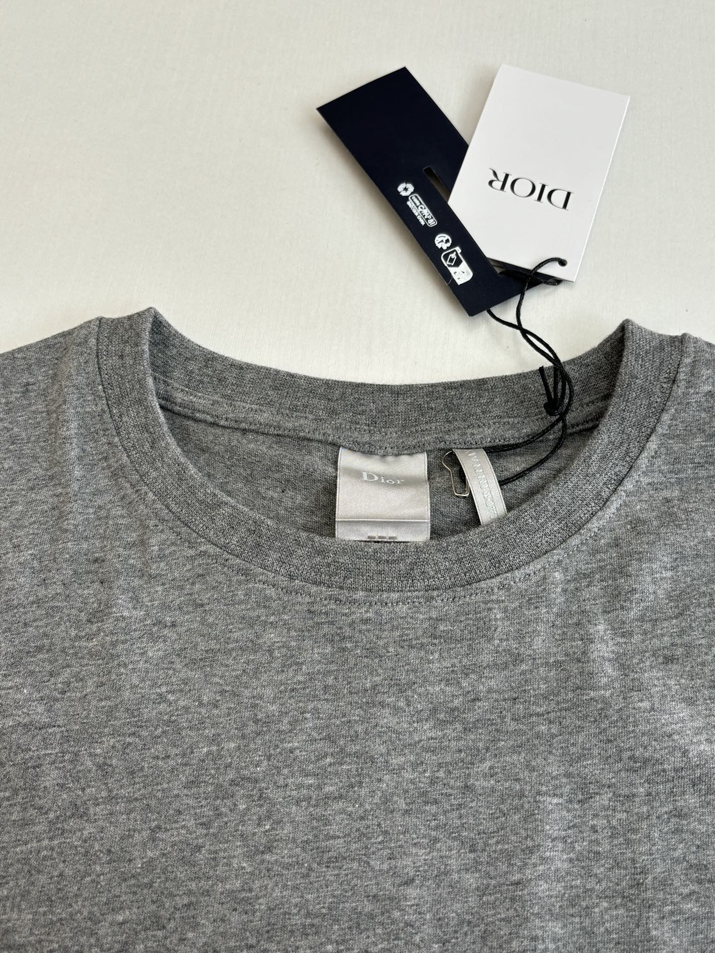 Gray crew-neck T-shirt with neck label and inside seam detail