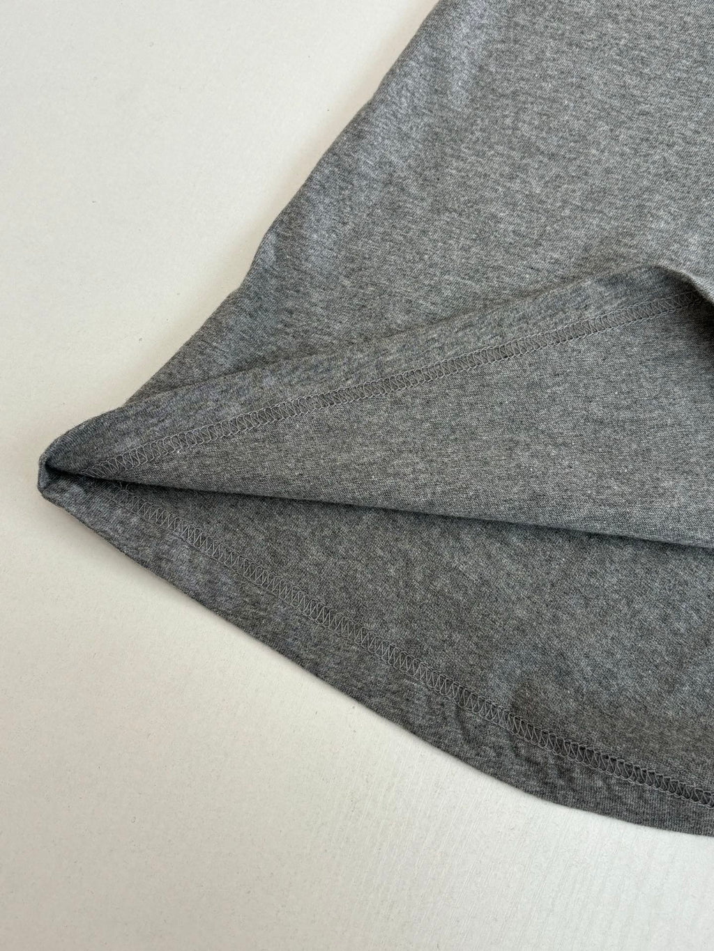 Gray short-sleeve T-shirt sleeve and curved hem detail