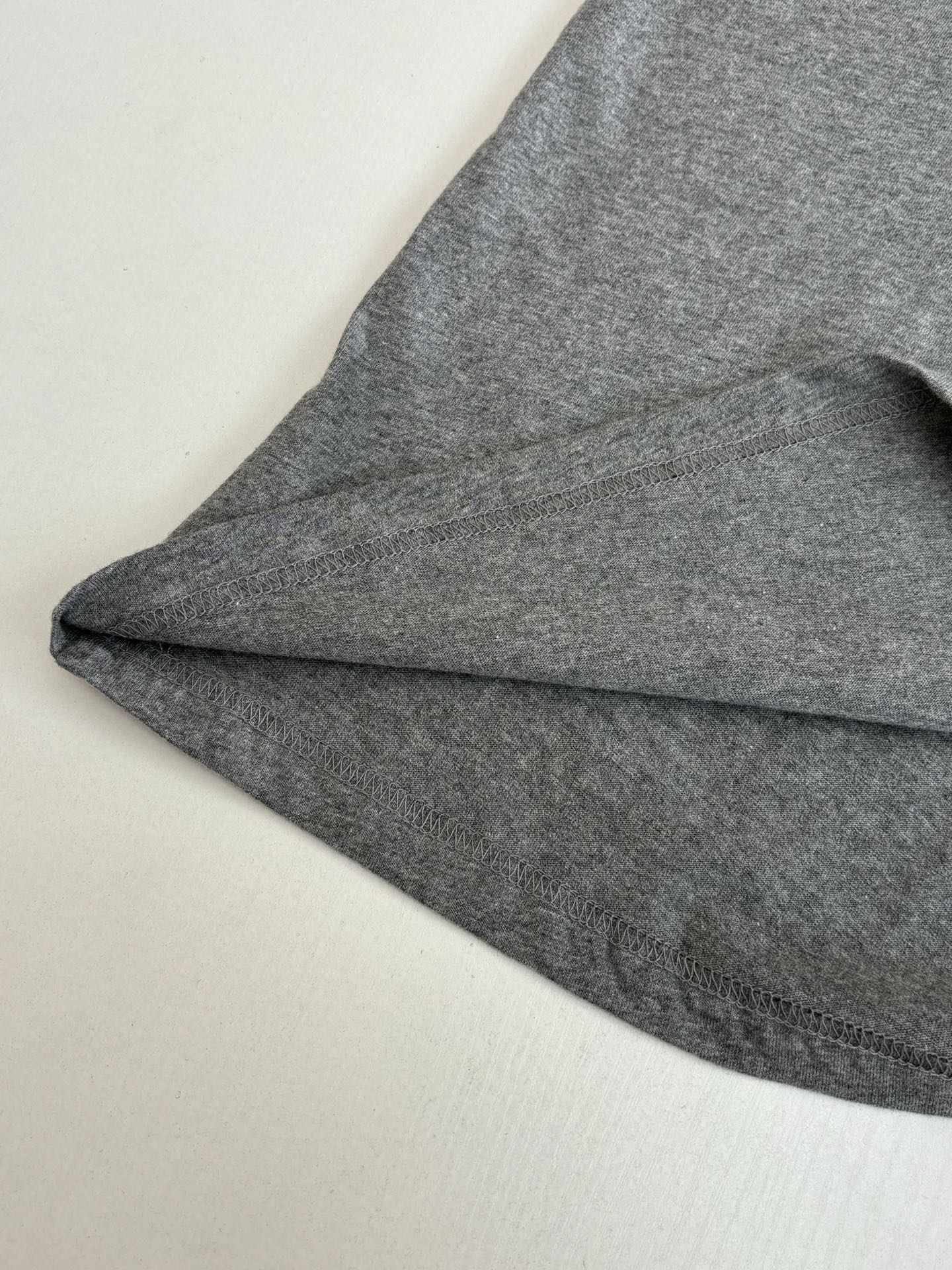 Gray short-sleeve T-shirt sleeve and curved hem detail