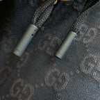Gucci fabric label detail on dark blue GG logo shorts