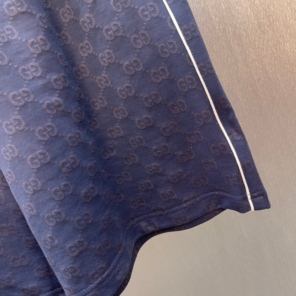 Gucci shorts close-up of side hem, GG logo pattern and contrast piping