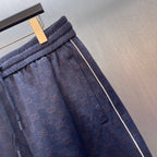 Gucci shorts waistband and side pocket detail, dark blue GG logo pattern