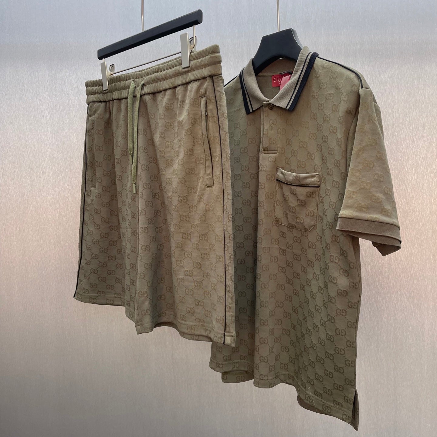 GG monogram shorts with elastic waistband, shown with a matching polo.