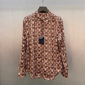 Long-sleeve button-up shirt with brown-and-cream monogram pattern, stand collar
