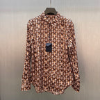 Long-sleeve button-up shirt with brown-and-cream monogram pattern, stand collar