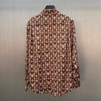 Long-sleeve button-up shirt with brown-and-cream monogram pattern, curved hem