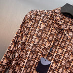 Long-sleeve button-up shirt with brown-and-cream monogram pattern, button placket