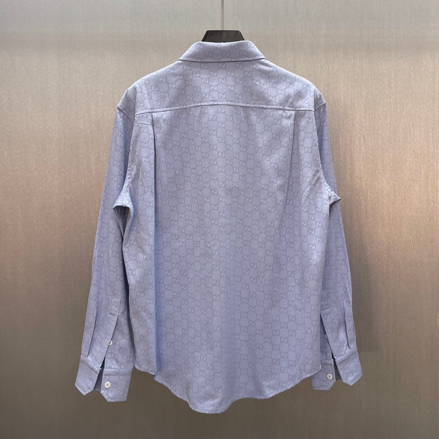 Light blue Gucci long-sleeve shirt back view with GG monogram print and button cuffs