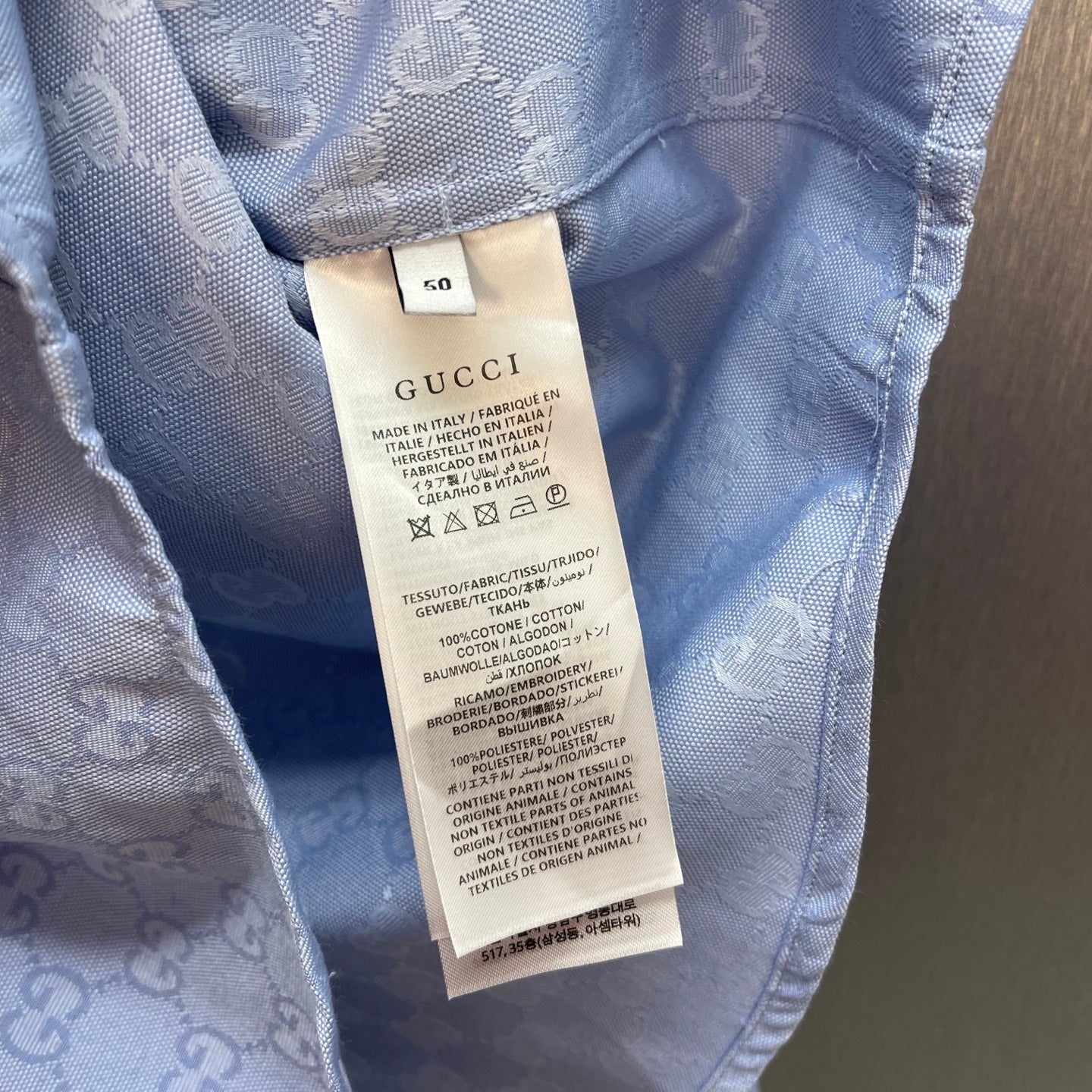 Light blue Gucci shirt size and care tag inside collar