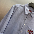 Light blue Gucci long-sleeve shirt detail with GG print, button placket, pocket logo patch