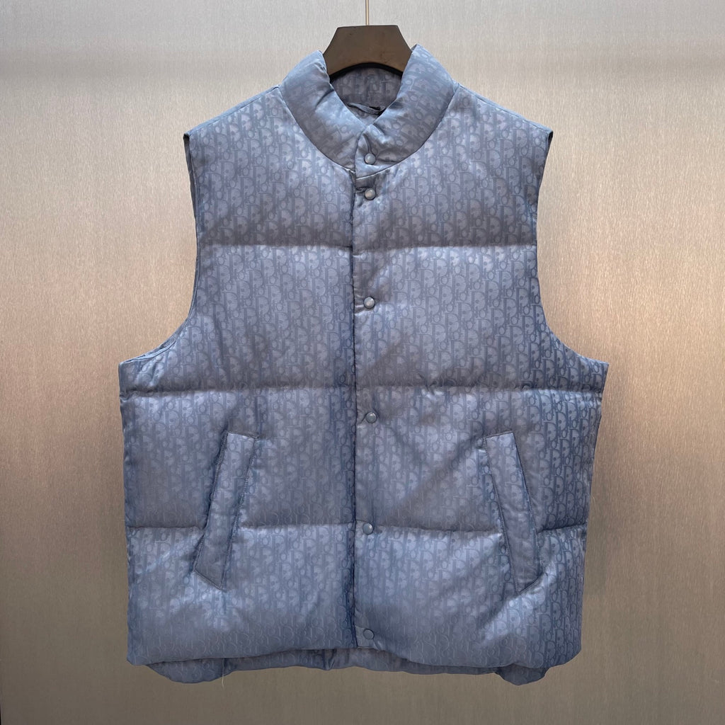 Quilted puffer vest with button front, stand collar, and monogram pattern in light blue
