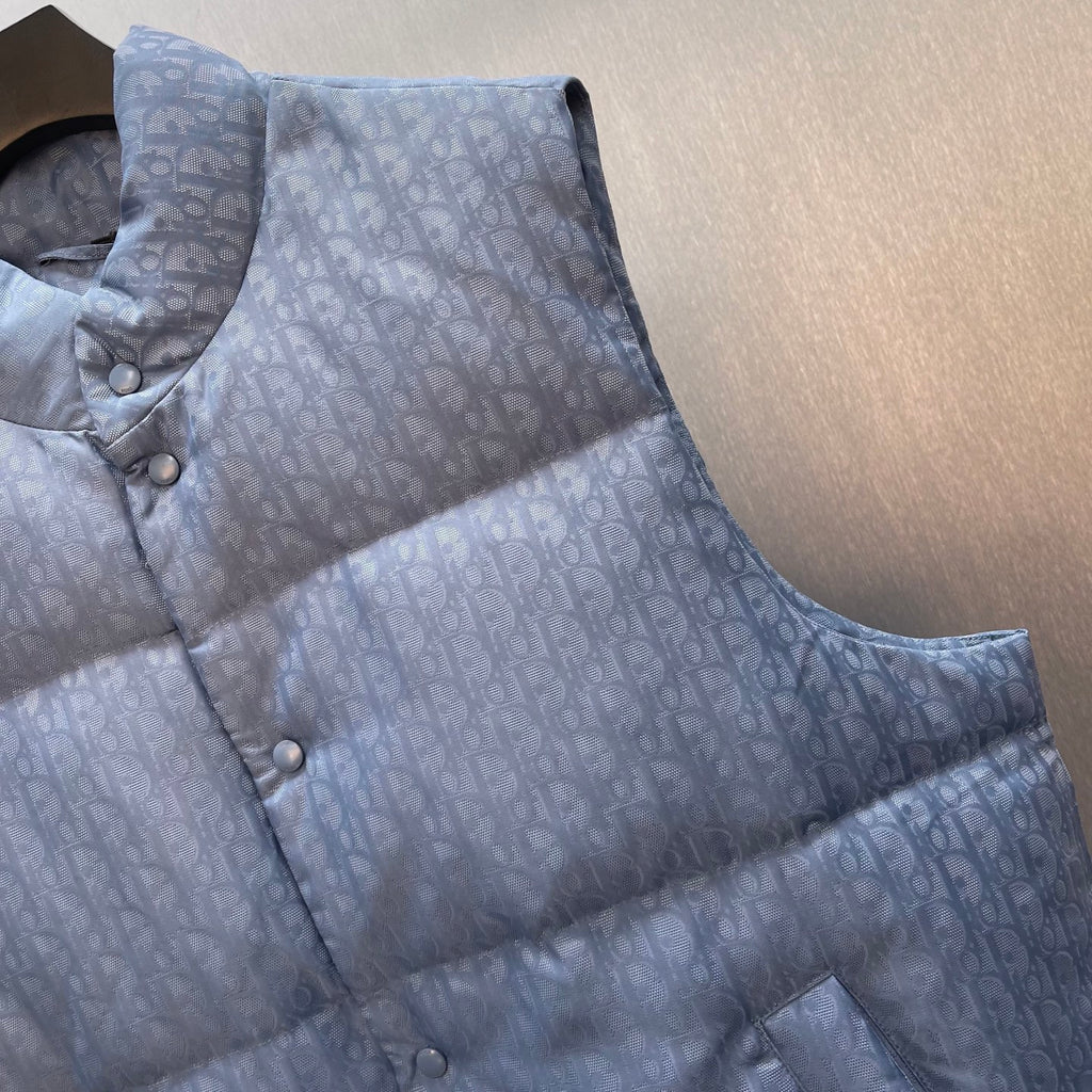 Light blue monogram quilted puffer vest with stand collar and button closure